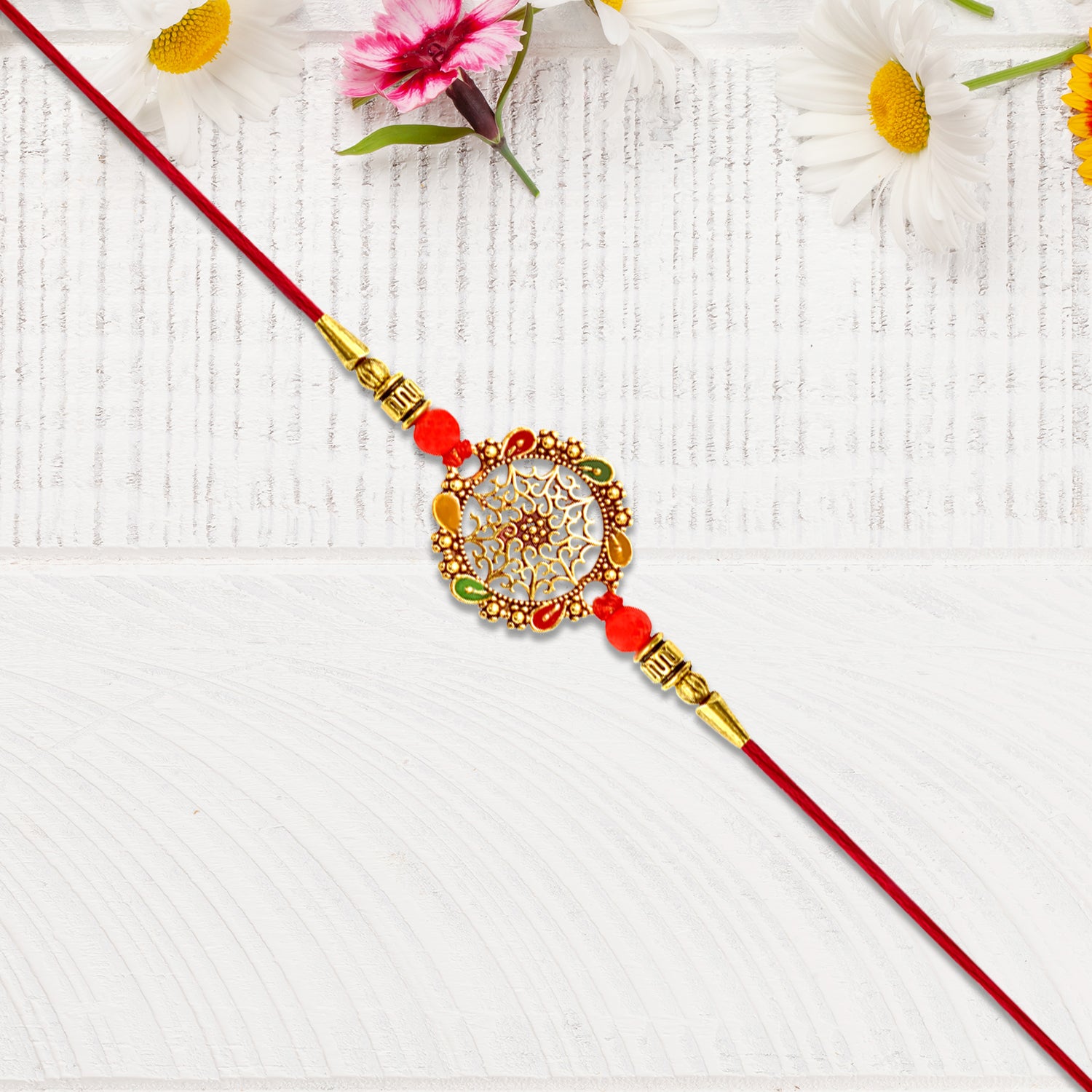 Intricately Designed Circular Rakhi With Multicolor Accents And Red Thread For Rakshabandhan Intricately Designed Circular Rakhi With Multicolor Accents And Red Thread For Rakshabandhan